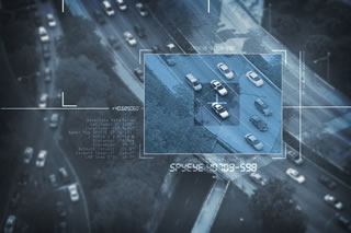 A graphic of a screen zooming in on a car from aerial view on a computer.