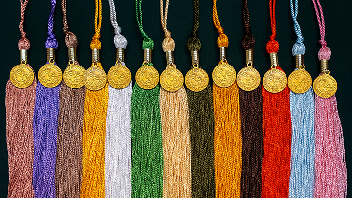tassels from all USF colleges laid out on a table