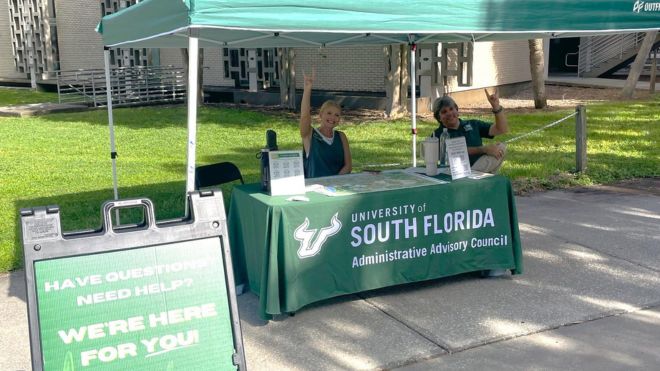 Two USF volunteers work at the AAC's Week-of-Welcome Information Station, providing information and directions to new students at the start of the Fall semester! 