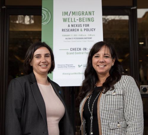 Im/migrant well-being: A nexus for research & policy conference. In this picture, the co-founders of the collaborative are shown: Dr. Liza Aranda and Dr. Eli Vaquera. 