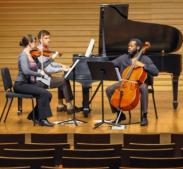Student-musicians playing during a chamber music rehearsal.