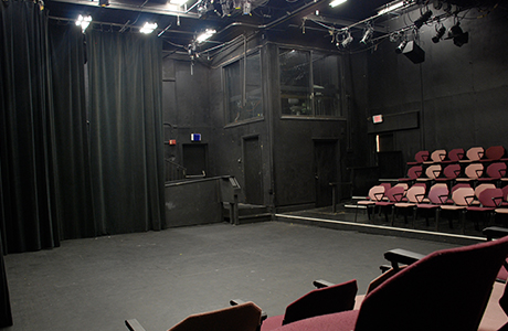 Black box theatre view of seating and performance area.
