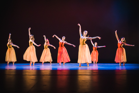 Dancers performing on stage in the Fall Dance Concert.