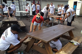Students painting picnic tables