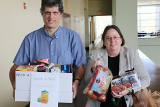 Staff holding food drive donations