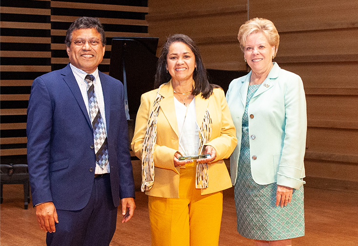 Maricel Hernandez accepts the award with President Rhea Law and Provost Prasant Mohapatra