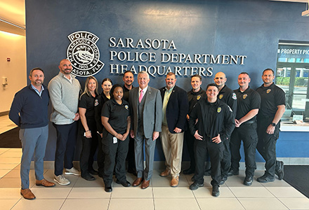 bob delany stands with members of the sarasota police department