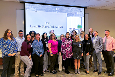 a group of people pose after being awarded with their lean six sigma certification