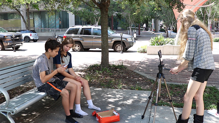 Students film outside the Tampa Theatre during summer film camp