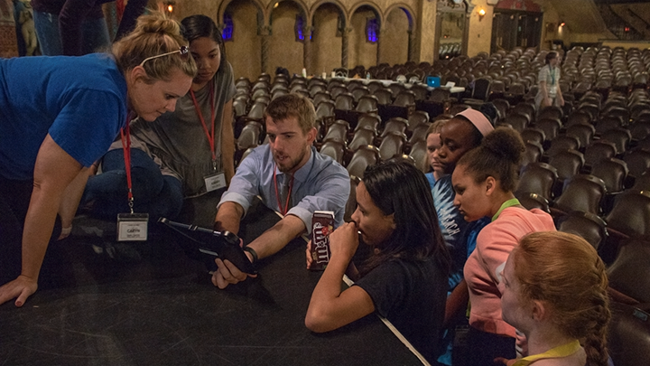 Camp director Nate Wolkenhauer and other camp counselors help students plan out a shot for their film