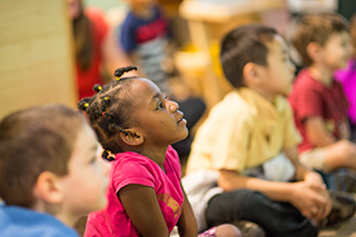 USF Preschool student listening in a classroom