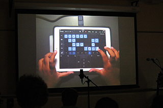 Student presenting iPad music creation at closing showcase