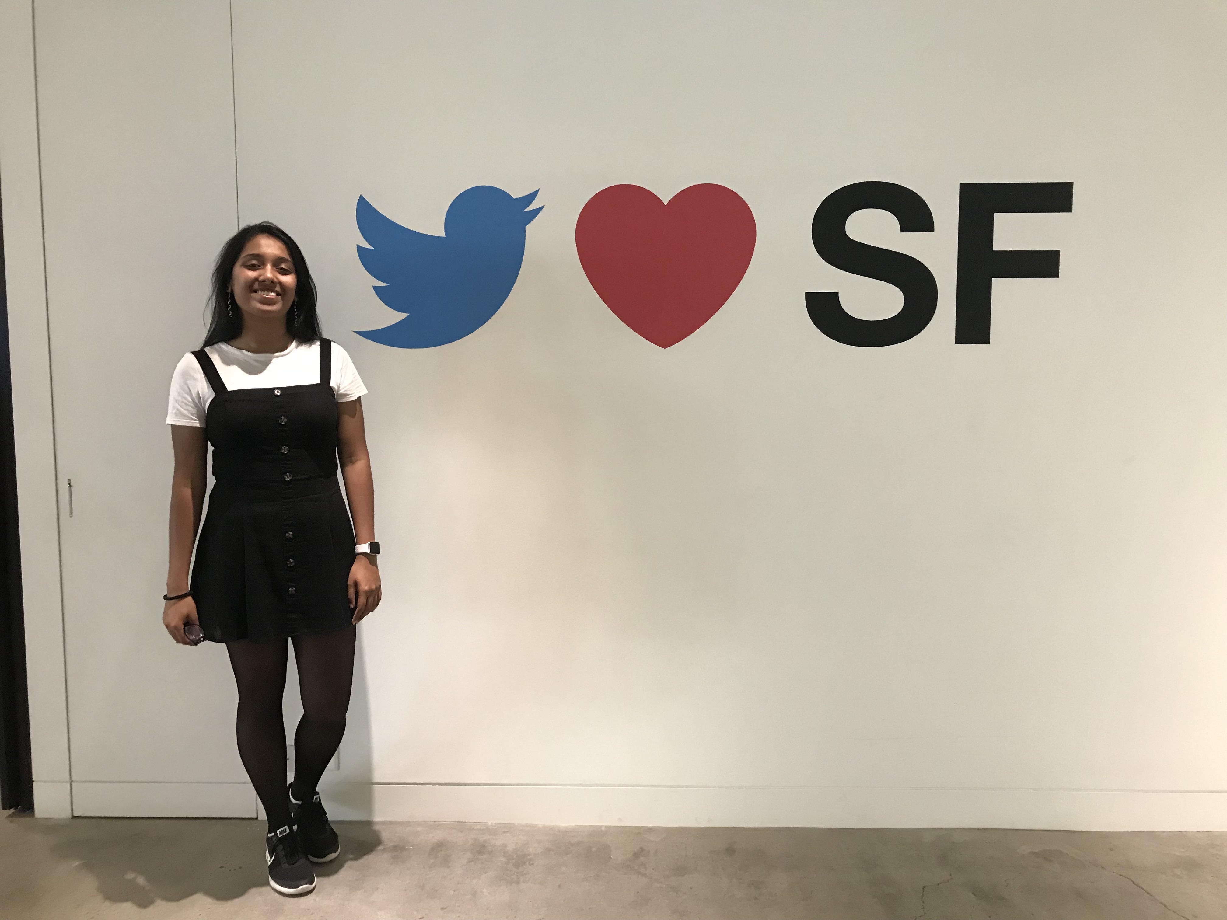 Blanche Pinto next to a mural at Twitter HQ