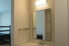 Sink and mirror above with entrance to room