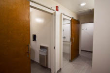 traditional dorm bathroom, two shower stalls with sliding door