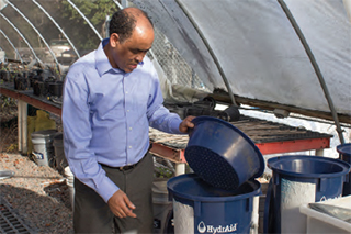 Kebreab Ghebremichael, PhD, demonstrates a biosand filter.