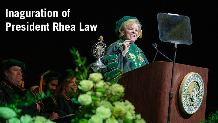 Rhea Law standing behind a podium with the USF seal with text reading "Inaguration of President Rhea Law".