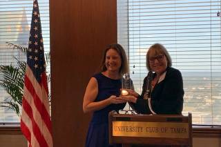 Amanda Maurer accepting the Tampa Bay Person of the Year Award from the Tampa Bay Organization of Women in Trade