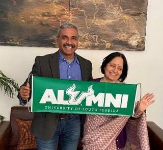 Medical Director and USF alumnus Dr. Sumit Ray and Aruna Dasgupta proudly display a USF alumni banner at Holy Family Hospital in India