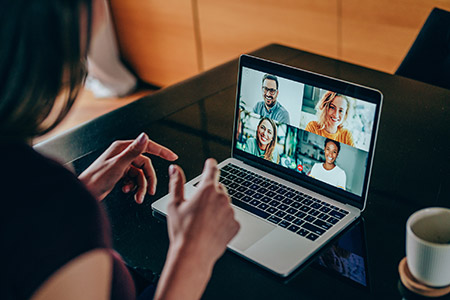 Person collaborating on a video chat with colleagues