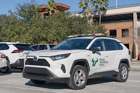 An SUV equipped with license plate recognition technology patrols a parking lot on campus.