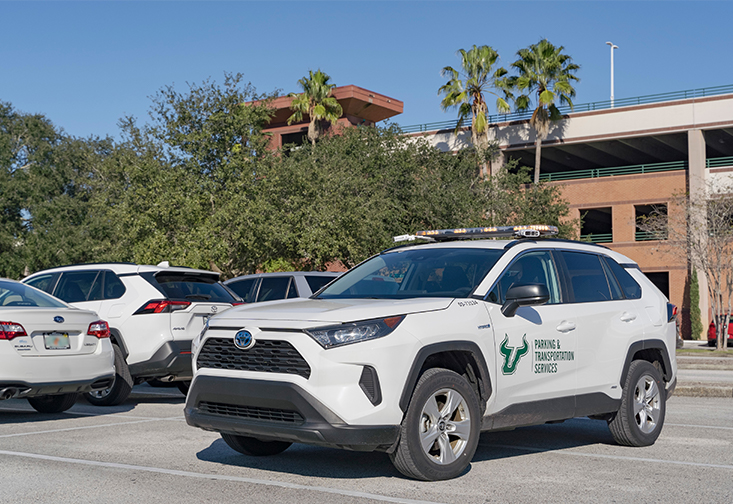 An SUV equipped with license plate recognition technology patrols a parking lot on campus. 