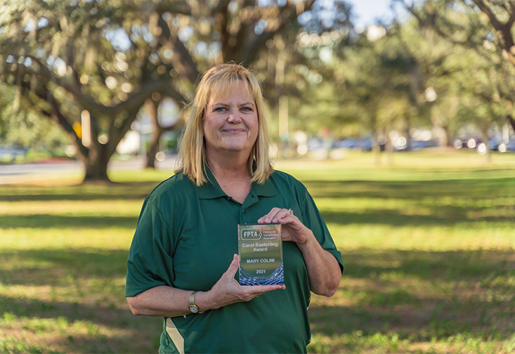 Mary Colini holding her Carol Easterinling Award. 