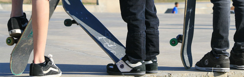 Close up of the feet and skateboards of skateboarders.