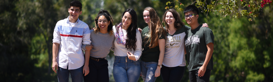 USF students taking a photo near the on-campus fountain.