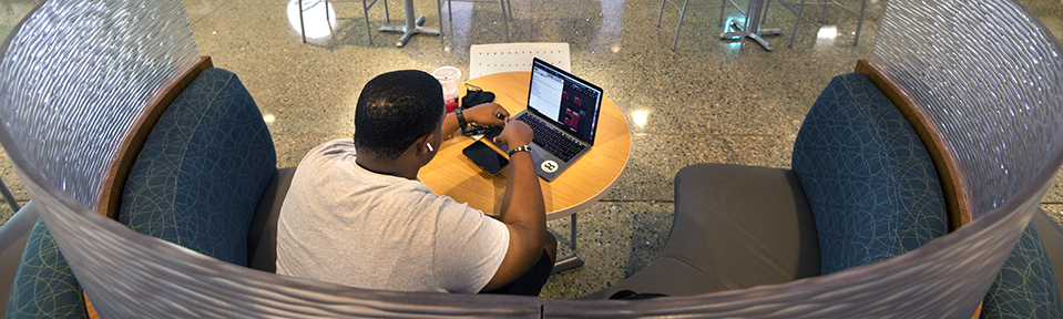 Student studying in a booth on campus.