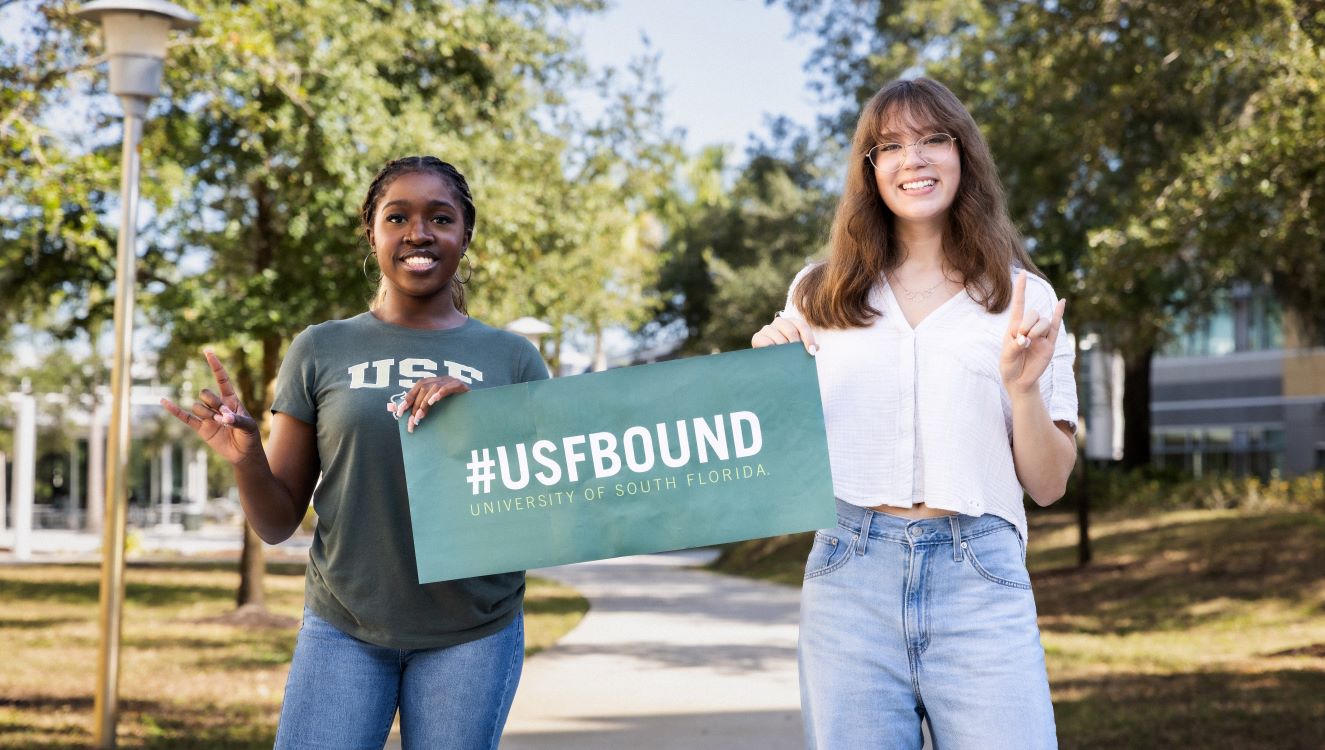 Two students holding a banner that reads USF Bound