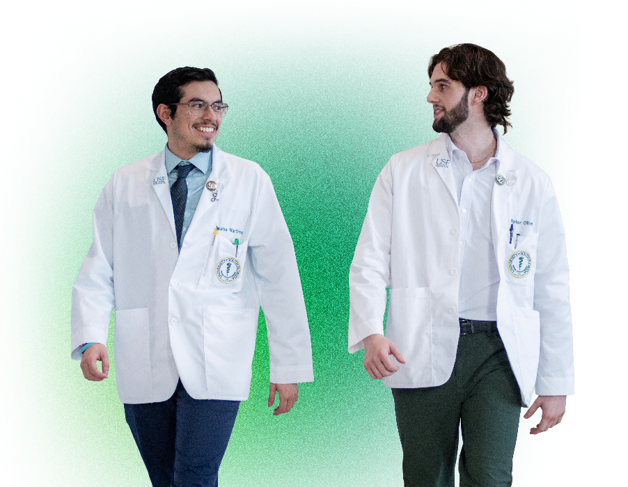 Two USF Health students chatting and walking.