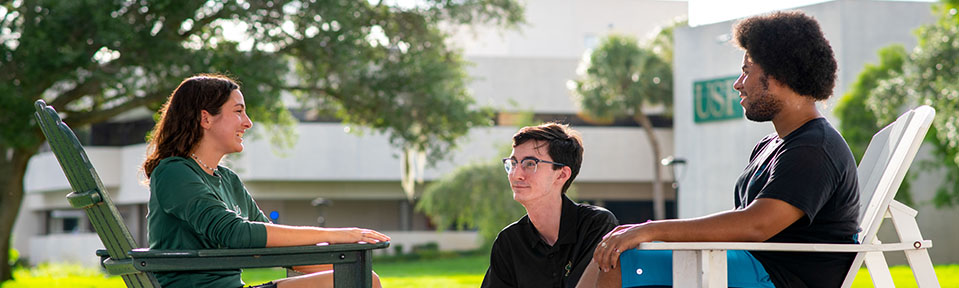 Three USF freshmen students hanging out together on campus.