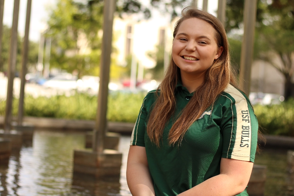 A USF student smiling on campus.