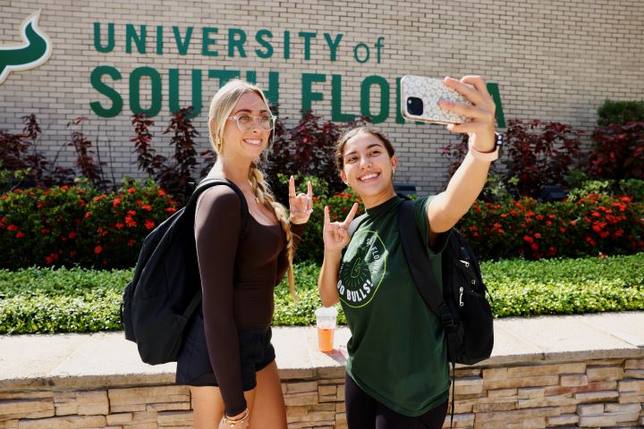 two USF students taking a selfie on campus