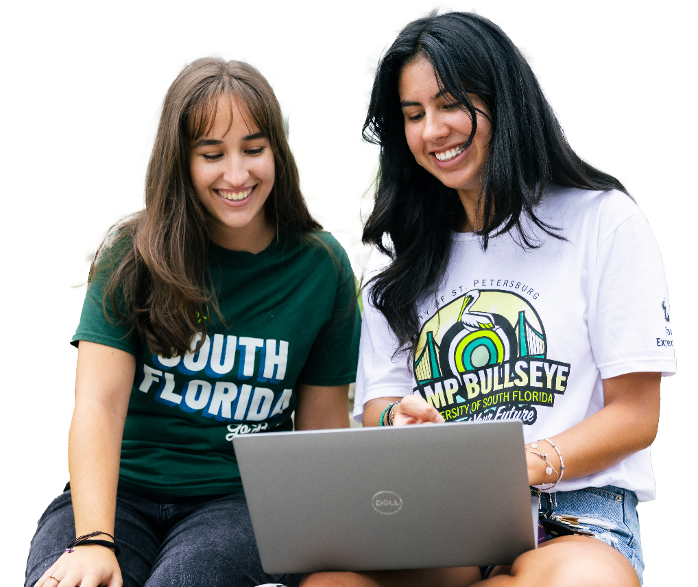 Two USF students looking at a laptop together.