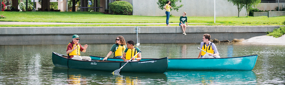 Students canoeing with their instructor on campus.