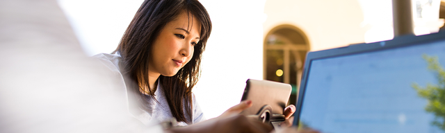 An international USF student using her tablet on campus.