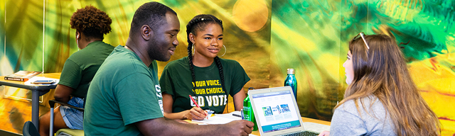 Three international USF students studying together.