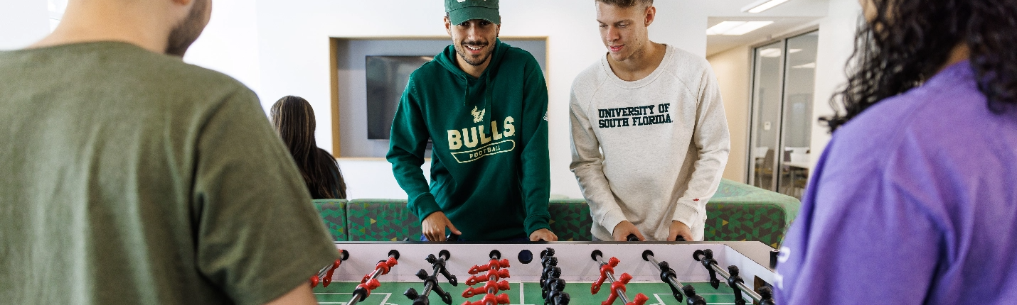 A group of students playing table football.