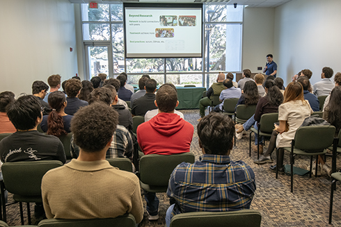 Students listen to presenters at the symposium