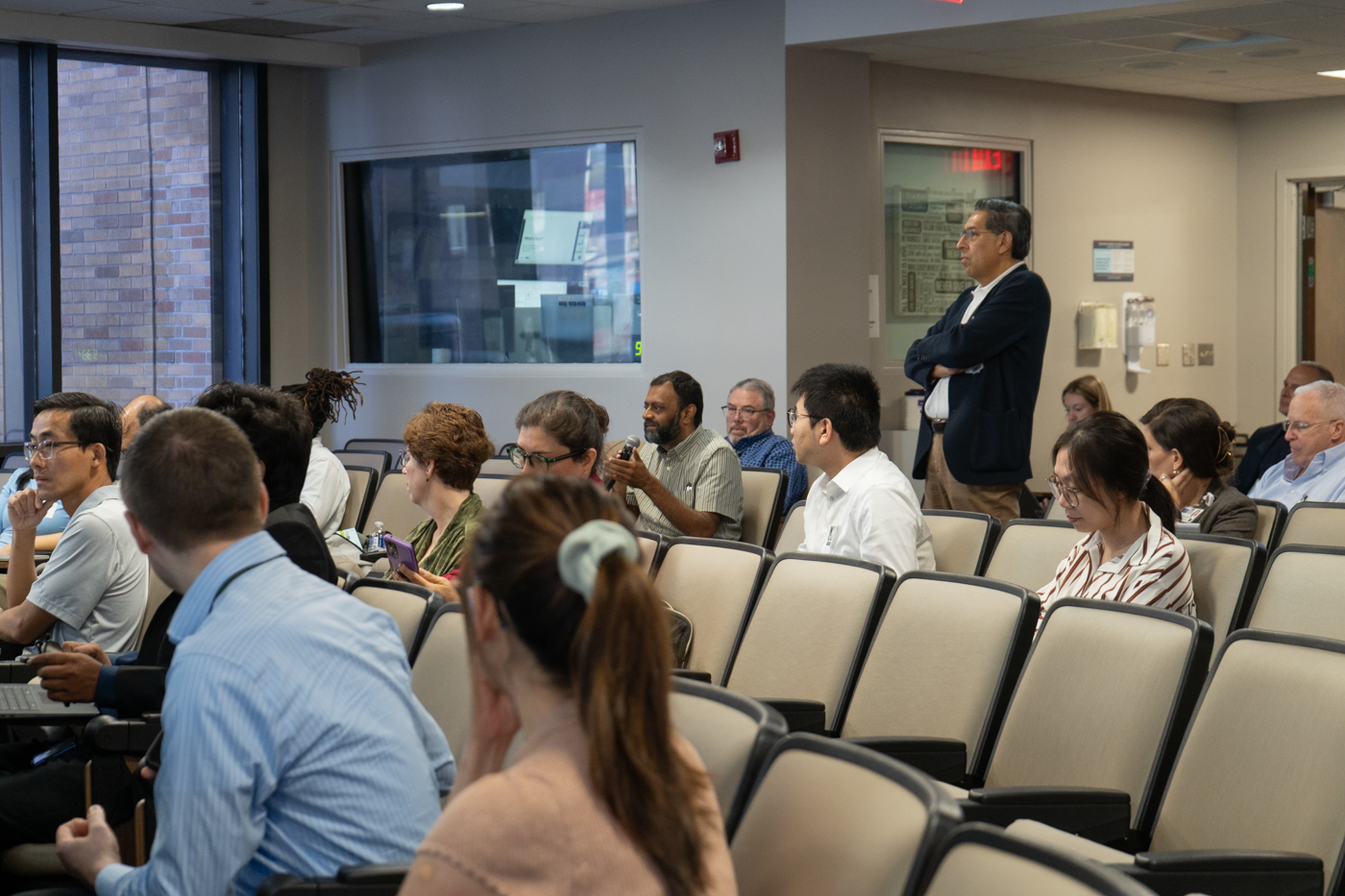 Audience members ask questions during a recent joint meeting with staff and faculty from the USF Bellini College and Tampa General Hospital.