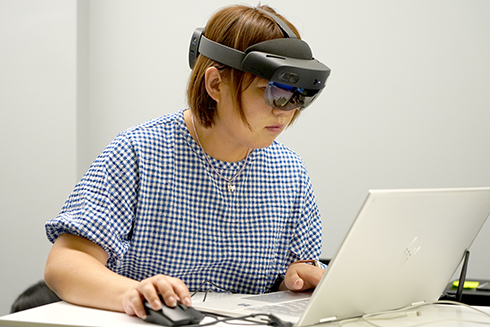 Xiangfei wearing AI goggles for augmented reality research