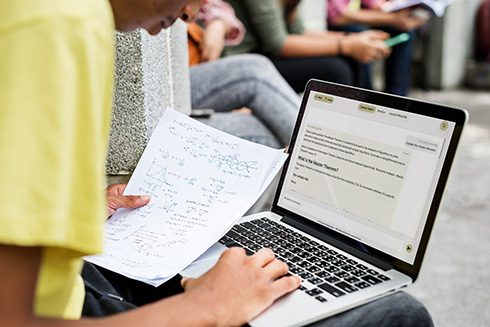 Student typing on a computer