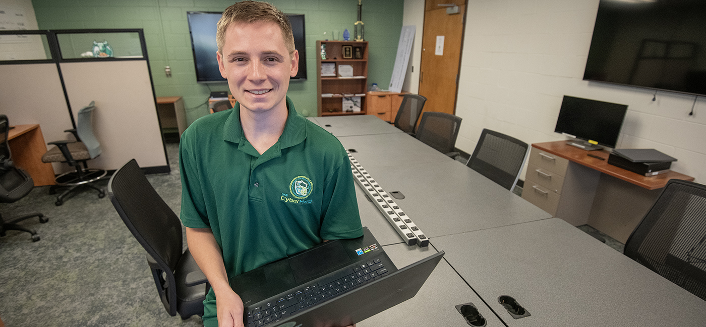 Jackson Liveringhouse sits inside the new CyberHerd room where the team practices for its competitions.