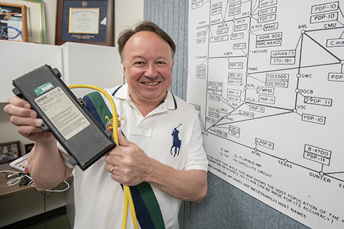 Associate Professor Richard Rauscher holds one of the original USF ethernet tranceivers. Rauscher built the University of South Florida’s first version of www.usf.edu in 1994, which ultimately reshaped the university’s future.
