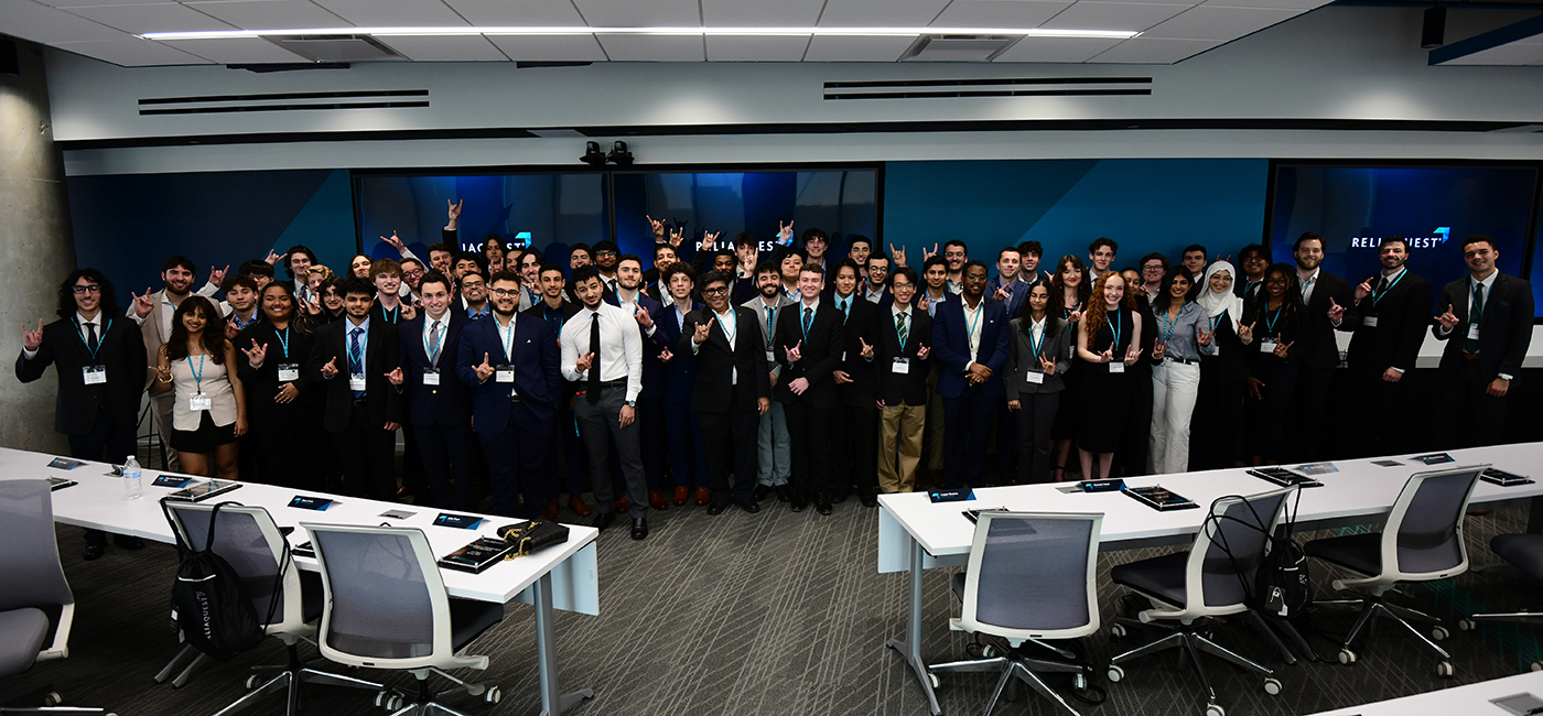 A group photo of the nearly 60 USF Bellini College graduates of the ReliaQuest Labs programs with dean Sudeep Sarkar.