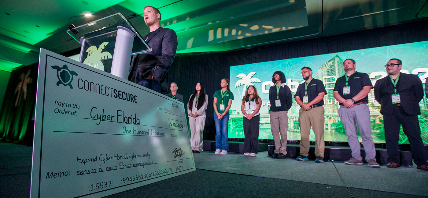 University of South Florida students and the university president accept an oversized check from Peter Bellini of connect secure.
