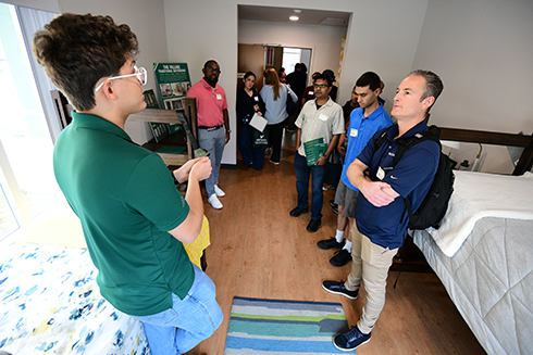 Parents and incoming students tour the new living learning community at the Bellini College.