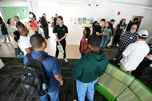 Parents and incoming students tour the new living learning community at the Bellini College.